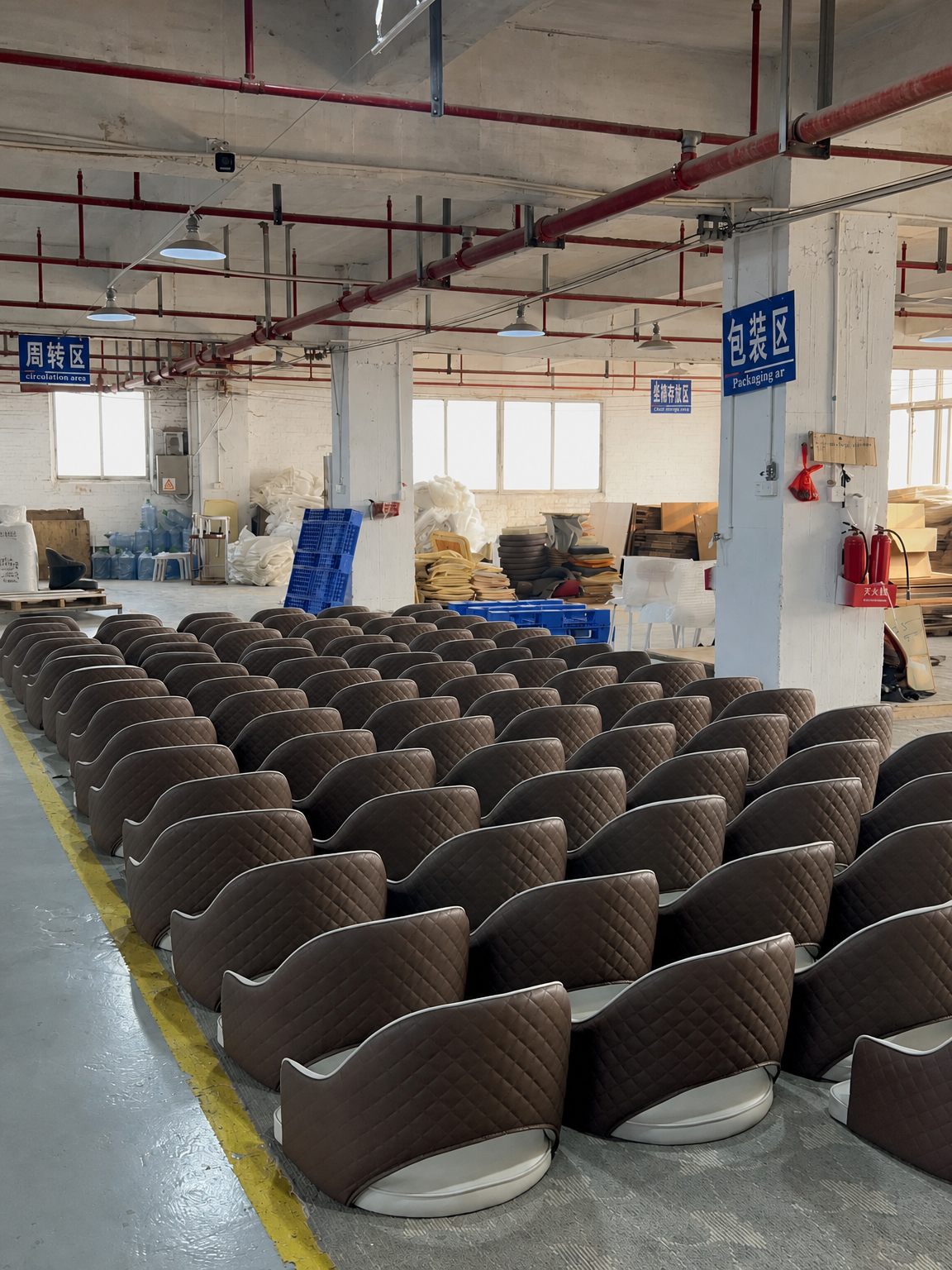 Rows of brown upholstered dining chairs in a furniture production area