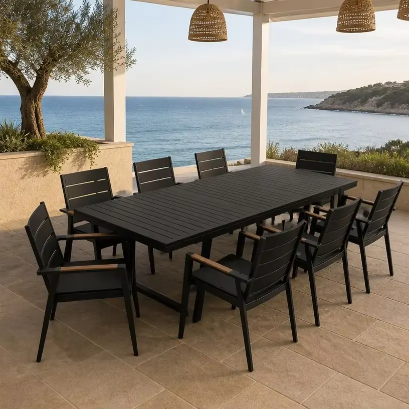 Black outdoor dining table and chair set in a seaside restaurant terrace